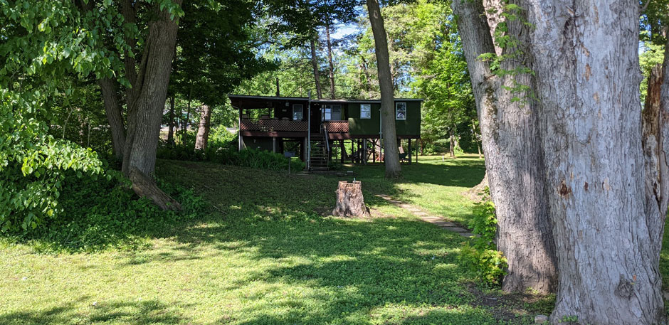 Back yard along river facing the cabin - Musky Lodge Susquehanna River Vacation Rental in Pennsylvania
